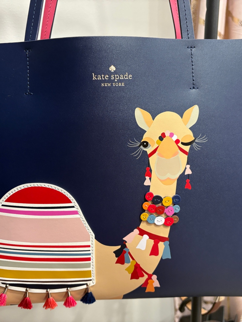 kate spade navy tote with colorful llama applique and tassel trim